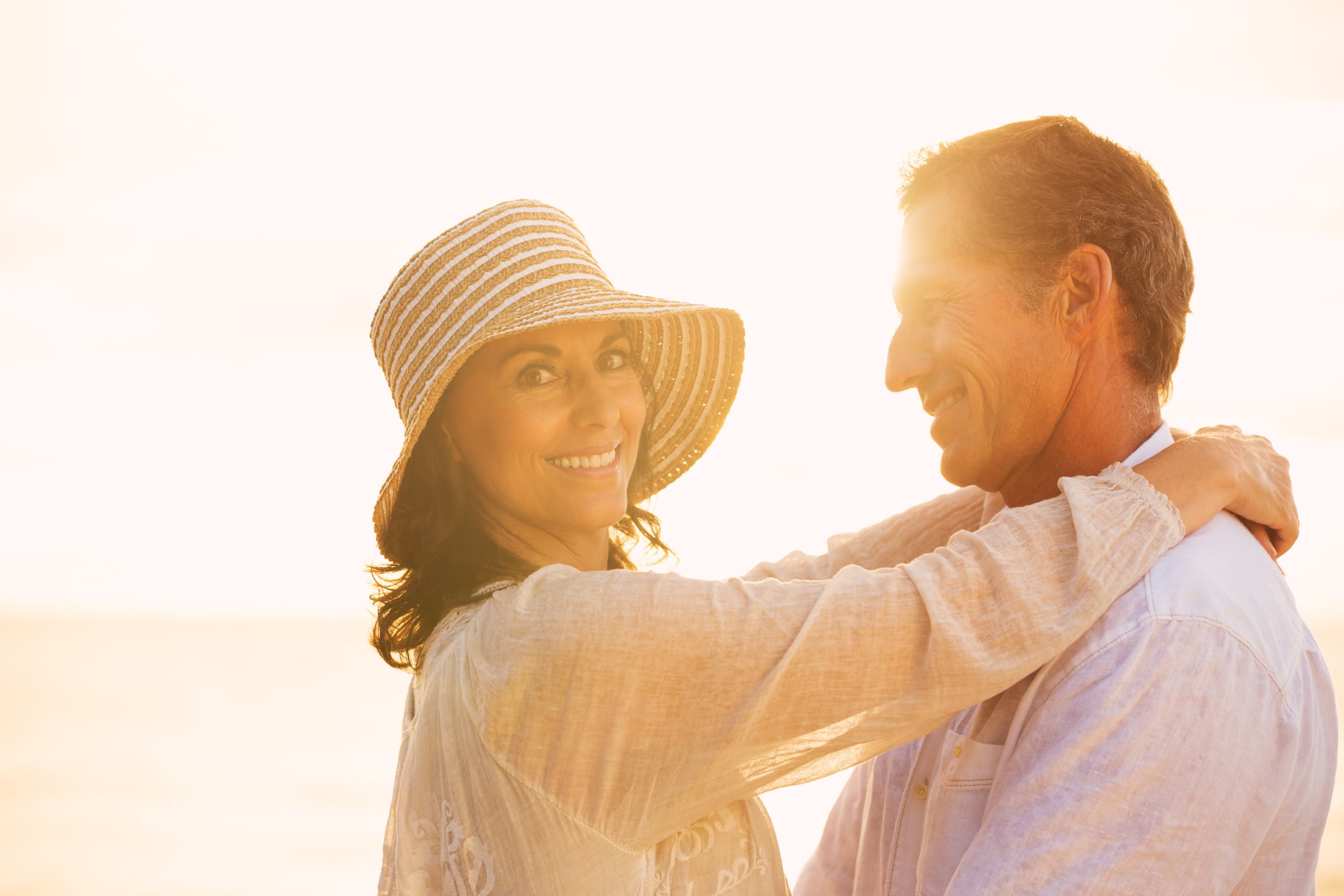 Happy Romantic Mature Couple in Love on the Beach at Sunset