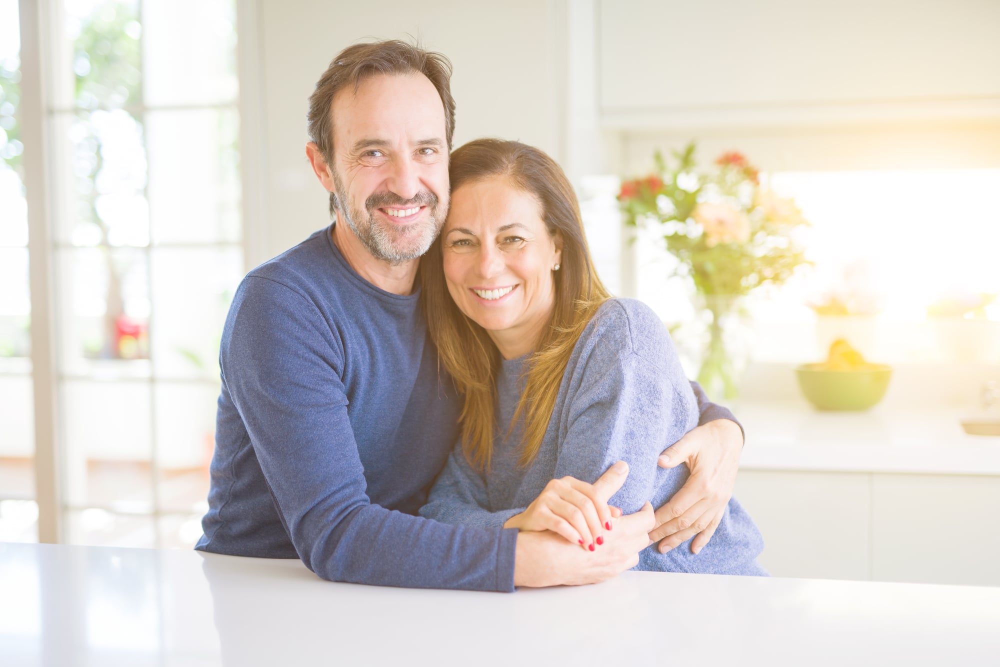 Romantic middle age couple sitting together at home